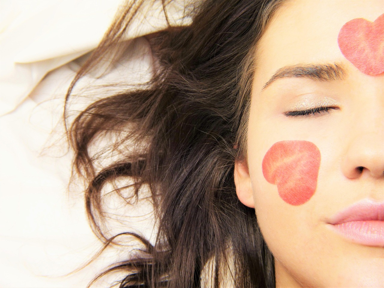 Skincare products and dropper on a soft cream backdrop