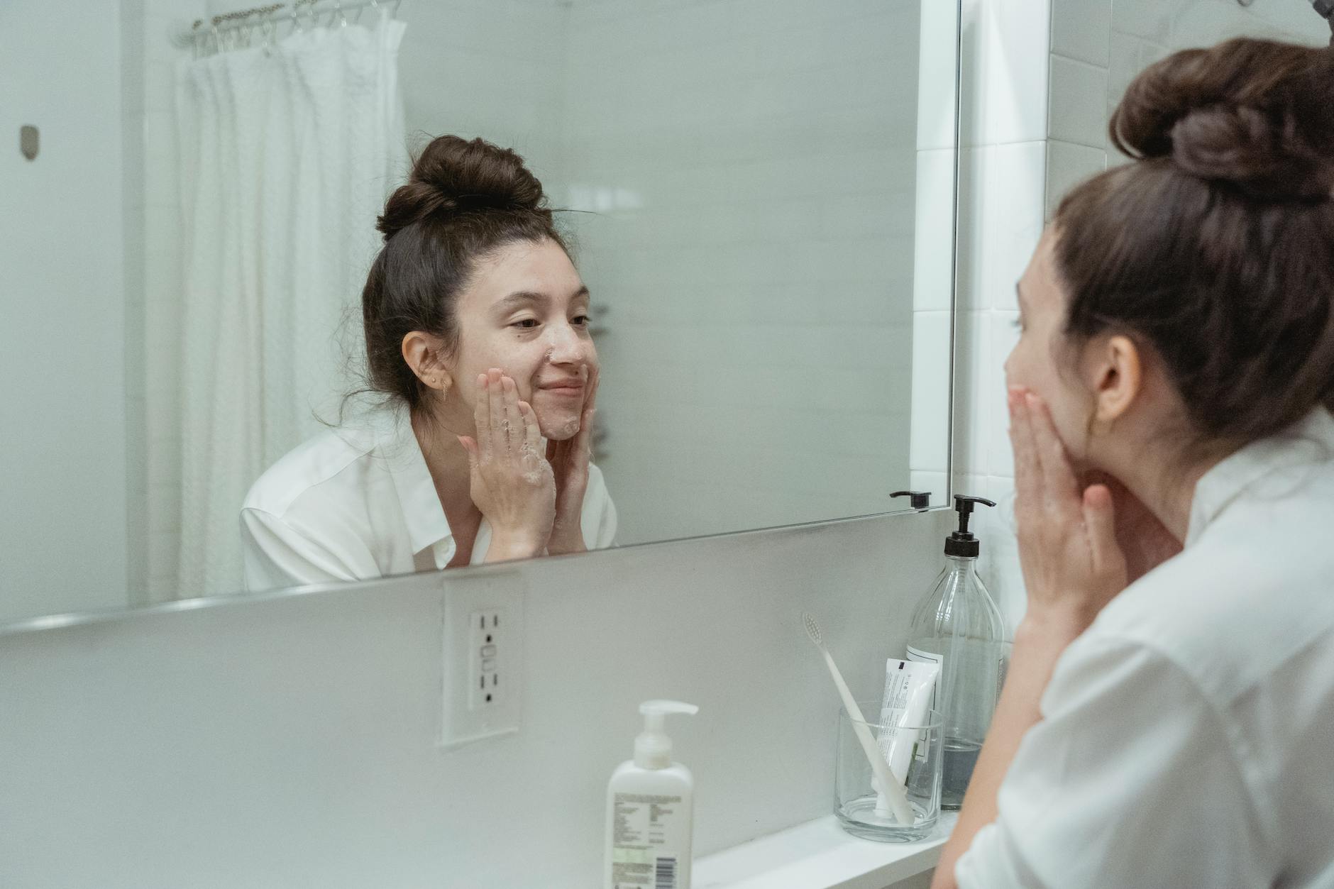 Skincare products and dropper on a soft cream backdrop